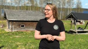 Nainen saunakylän edustalla.