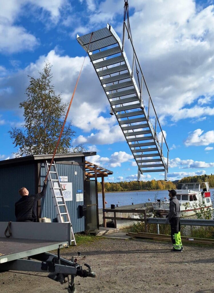 Järveen asennetaan portaita avantouimareita varten kesäpäivänä.