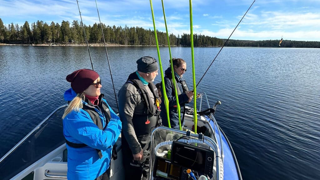 ihmisiä kalastusveneessä järvellä